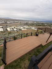 Expansive outdoor deck featuring wood-finish composite decking and black metal railings