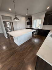 Kitchen island with a white paneled base and a light-toned countertop
