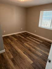 Wood-finish flooring throughout, complemented by neutral wall tones and white baseboards