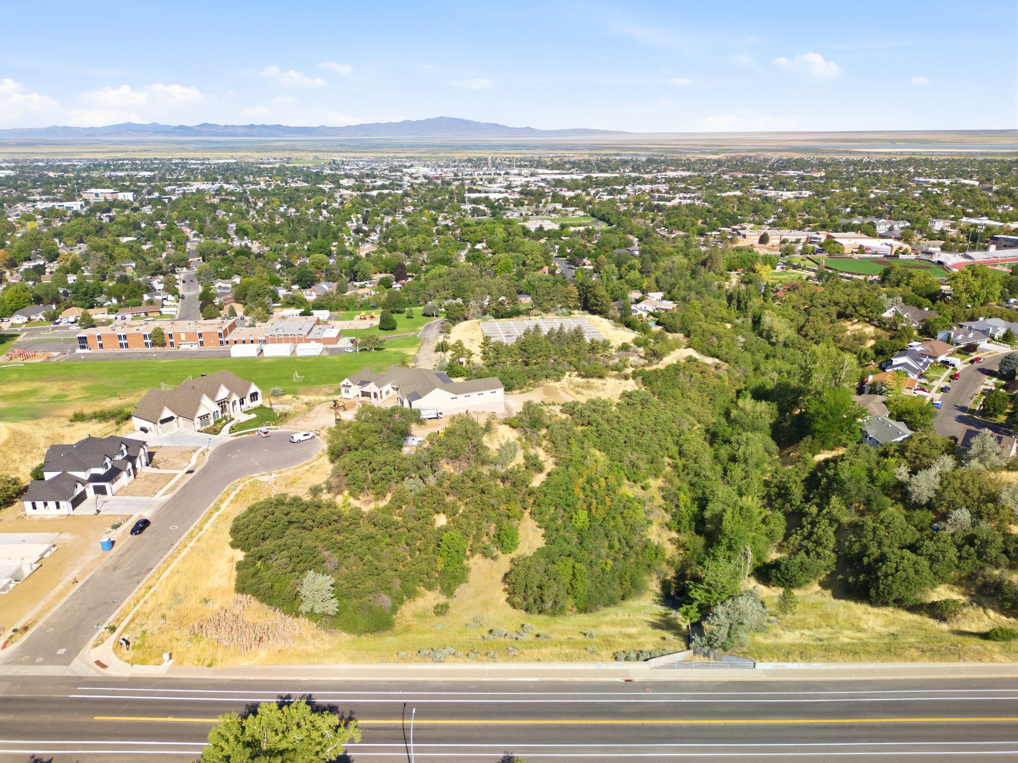 Expansive aerial perspective showcasing a developed residential area with surrounding natural landscapes