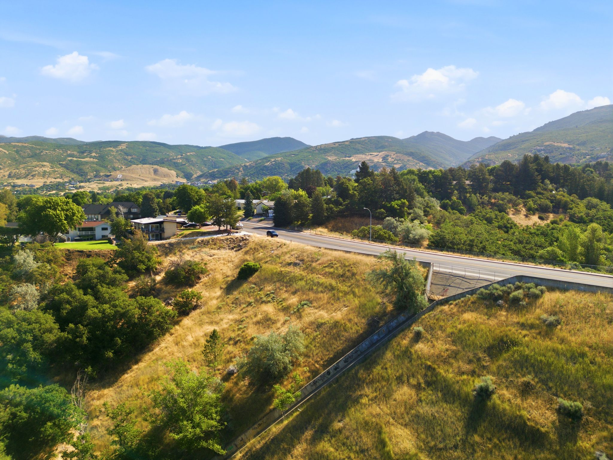 Expansive hillside property featuring varied terrain and mature trees