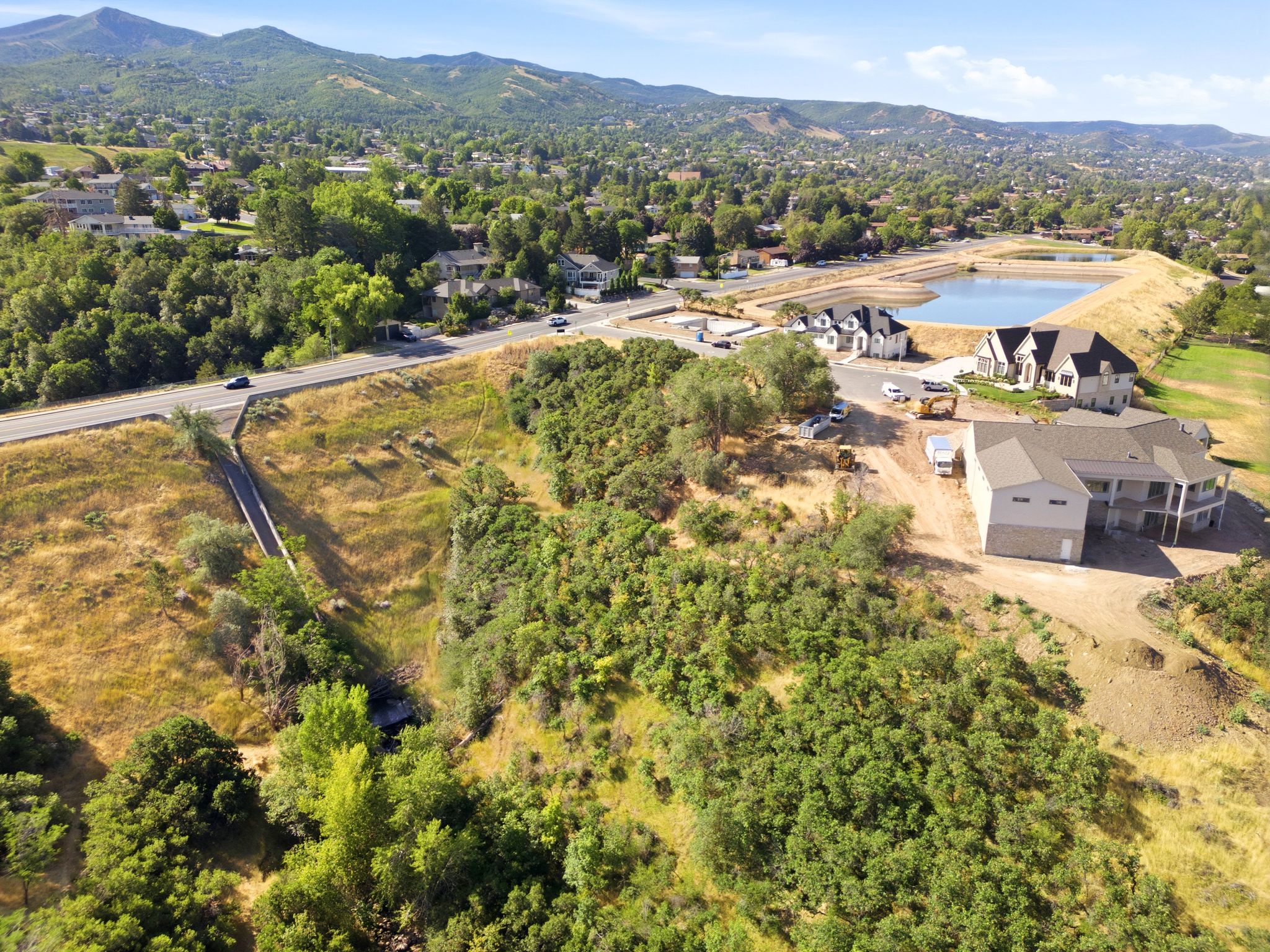 New construction properties featuring a stone and siding exterior, multi-level design, and covered outdoor living spaces