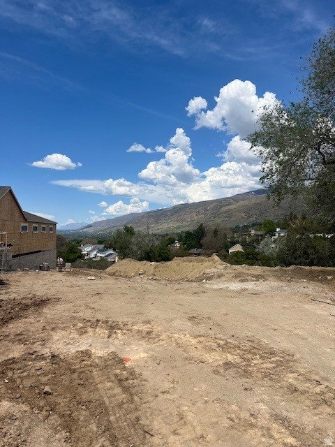 Expansive cleared lot with mountain backdrop