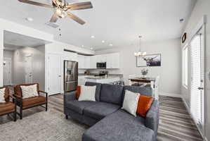 Open-concept living space featuring wood-finish flooring, recessed lighting, and a ceiling fan