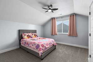 Carpeted room with a ceiling fan