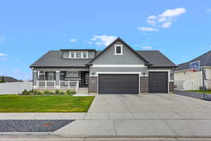 Contemporary stucco exterior with a covered porch featuring white railing and columns