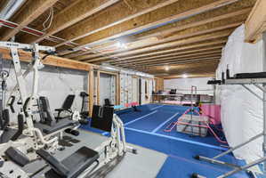 Unfinished basement with exposed wood joists and structural beams