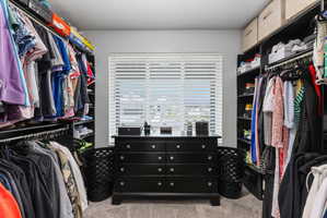 Custom closet system featuring extensive shelving and hanging rods