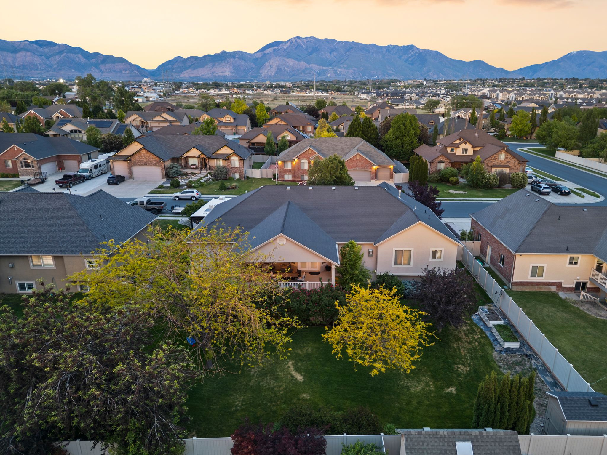 Aerial perspective showcasing a residential neighborhood with mountain scenery
