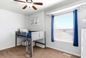 Room featuring light-colored walls and wood-finish ceiling fan