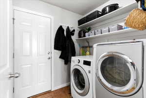Dedicated laundry area featuring a front-loading washing machine and dryer