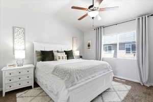 Bedroom featuring a vaulted ceiling and a ceiling fan with light fixture