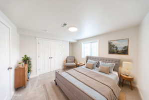 Carpeted room featuring a white interior door, a double-door closet with paneling, a window with blinds, and recessed lighting