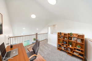 Loft area featuring vaulted ceilings and recessed lighting