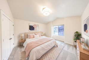 Carpeted room featuring a vaulted ceiling and a rectangular window