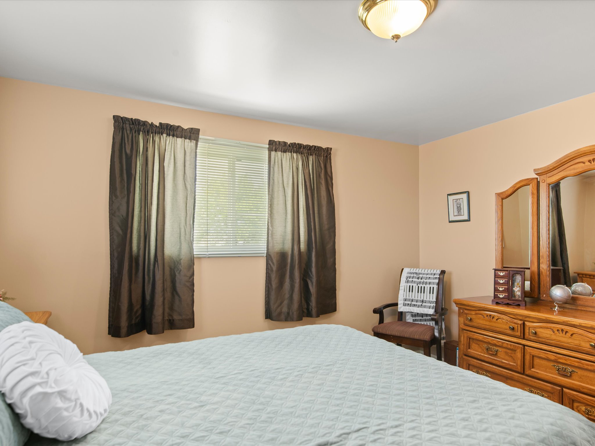 Room with beige walls, a window with blinds, and a flush mount light fixture