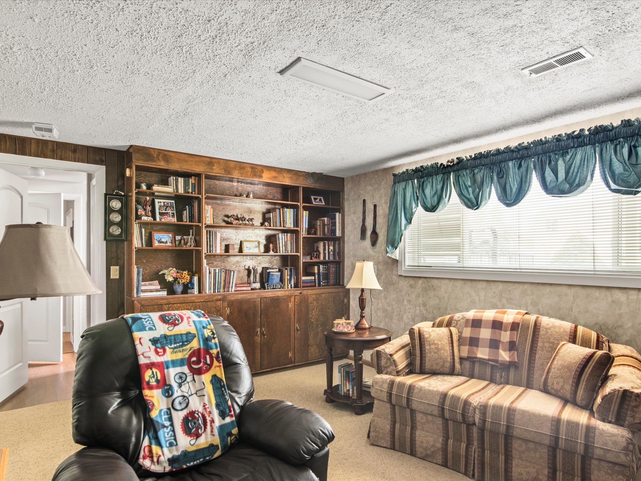 Built-in wood shelving and cabinetry providing extensive storage