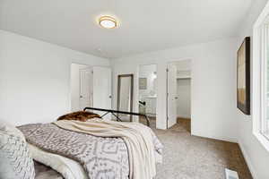 Carpeted room featuring white walls, a flush-mount ceiling light, and a window with white trim