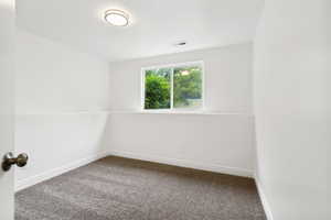 Room featuring neutral wall finishes and grey carpet