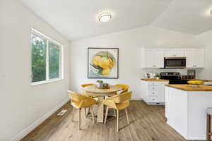 Bright dining area featuring wood-finish flooring and a white window frame