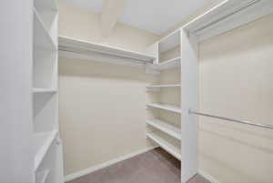 Custom closet system featuring white shelving and chrome hanging rods