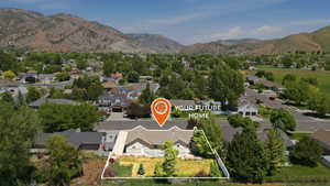 Single-story residence set on a spacious lot, featuring a rear patio and mature landscaping