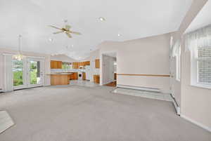 Open-concept living area with vaulted ceilings and recessed lighting