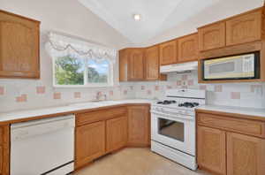 Kitchen featuring light wood cabinetry and light countertops
