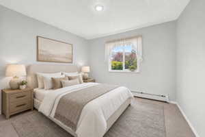 Virtual staging included to showcase room potential. Light-filled room featuring a single window with white trim, soft grey wall paint, recessed ceiling lighting, and light-toned carpeting