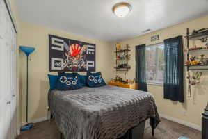 Neutral wall paint, ceiling-mounted light fixture, and a window with blinds and curtains