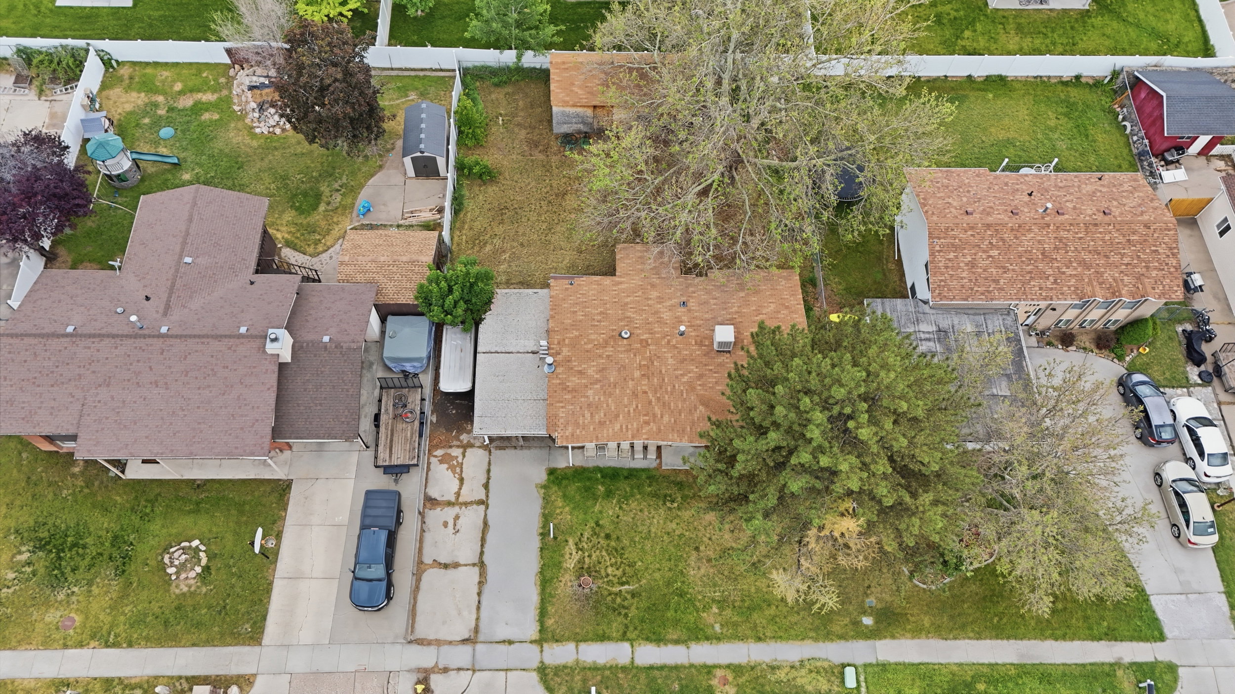 Single-story residence featuring a brown shingle roof and a concrete driveway