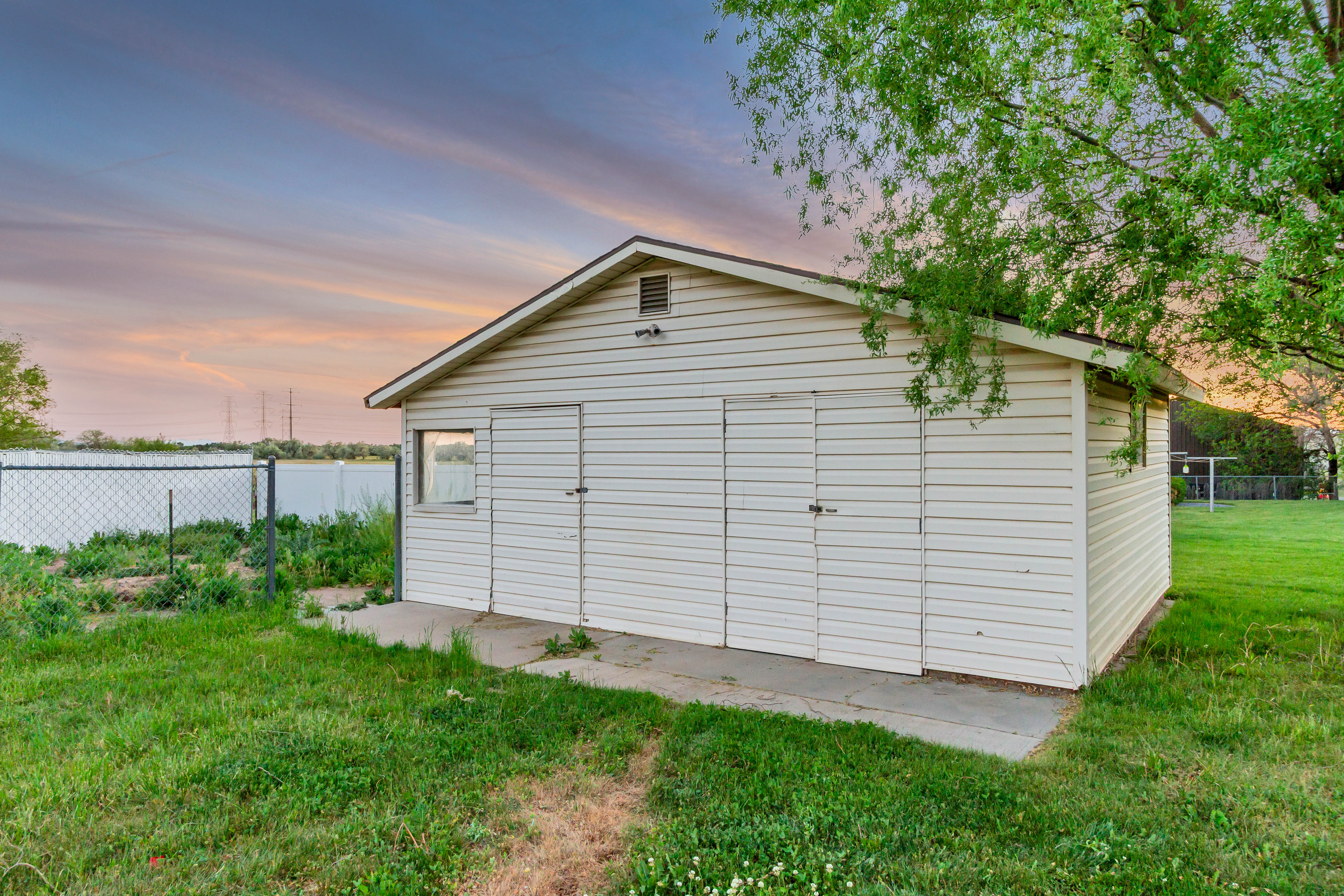 Detached outbuilding with horizontal siding and a gabled roof