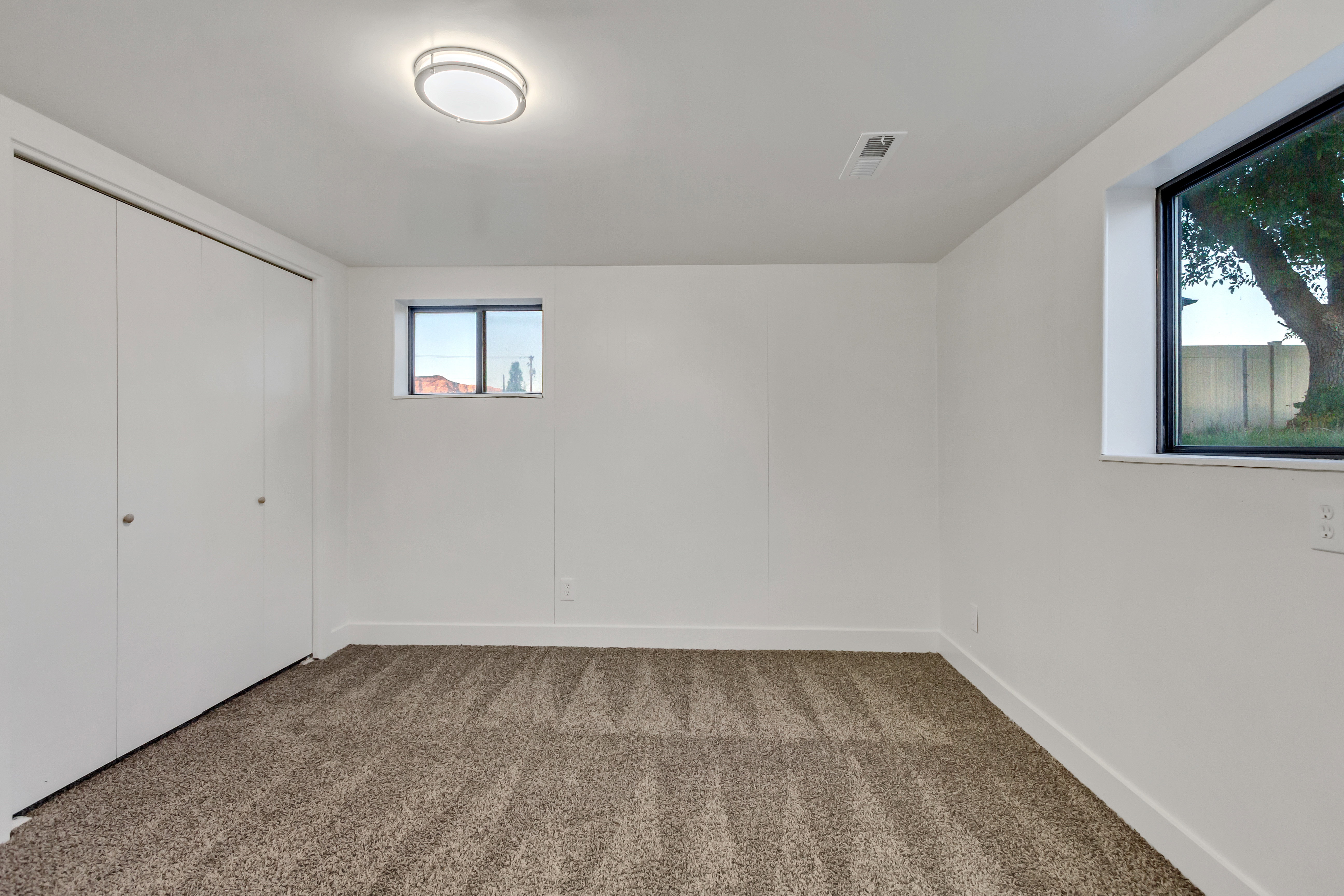 Room featuring neutral tone carpeting and crisp white walls