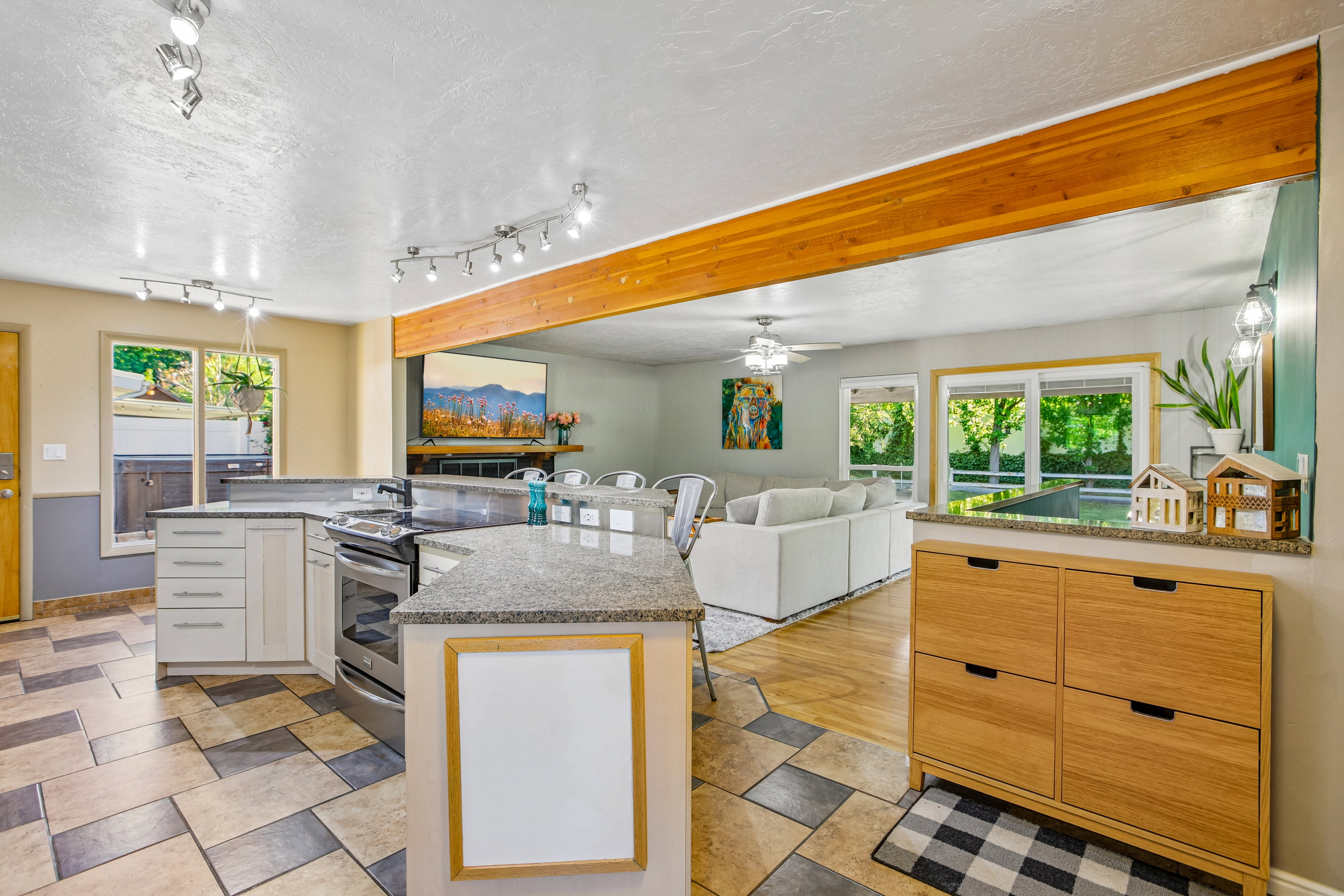 Kitchen featuring light-toned cabinetry, granite countertops, and stainless steel appliances