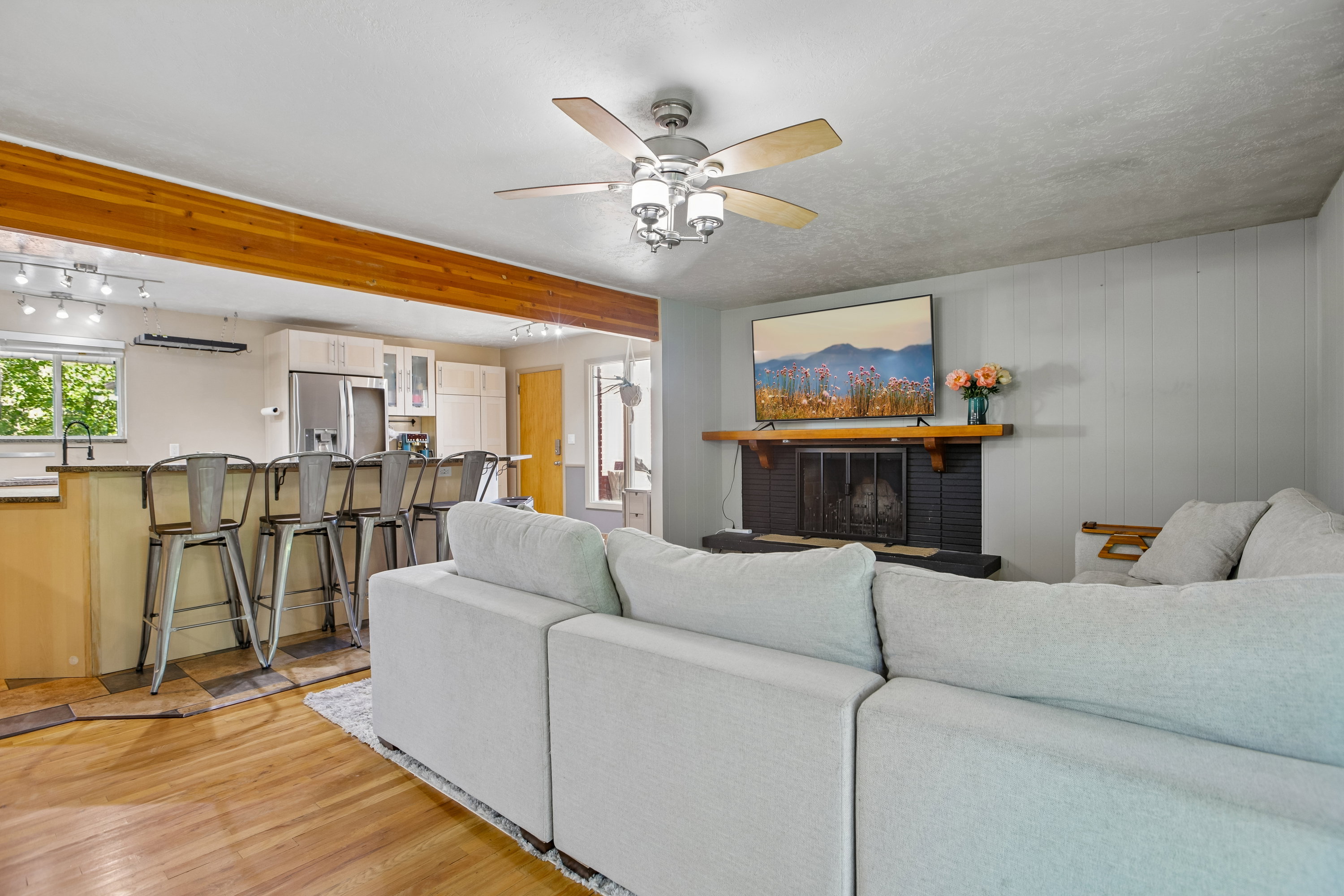 Living area featuring a fireplace with a black surround and wood mantel
