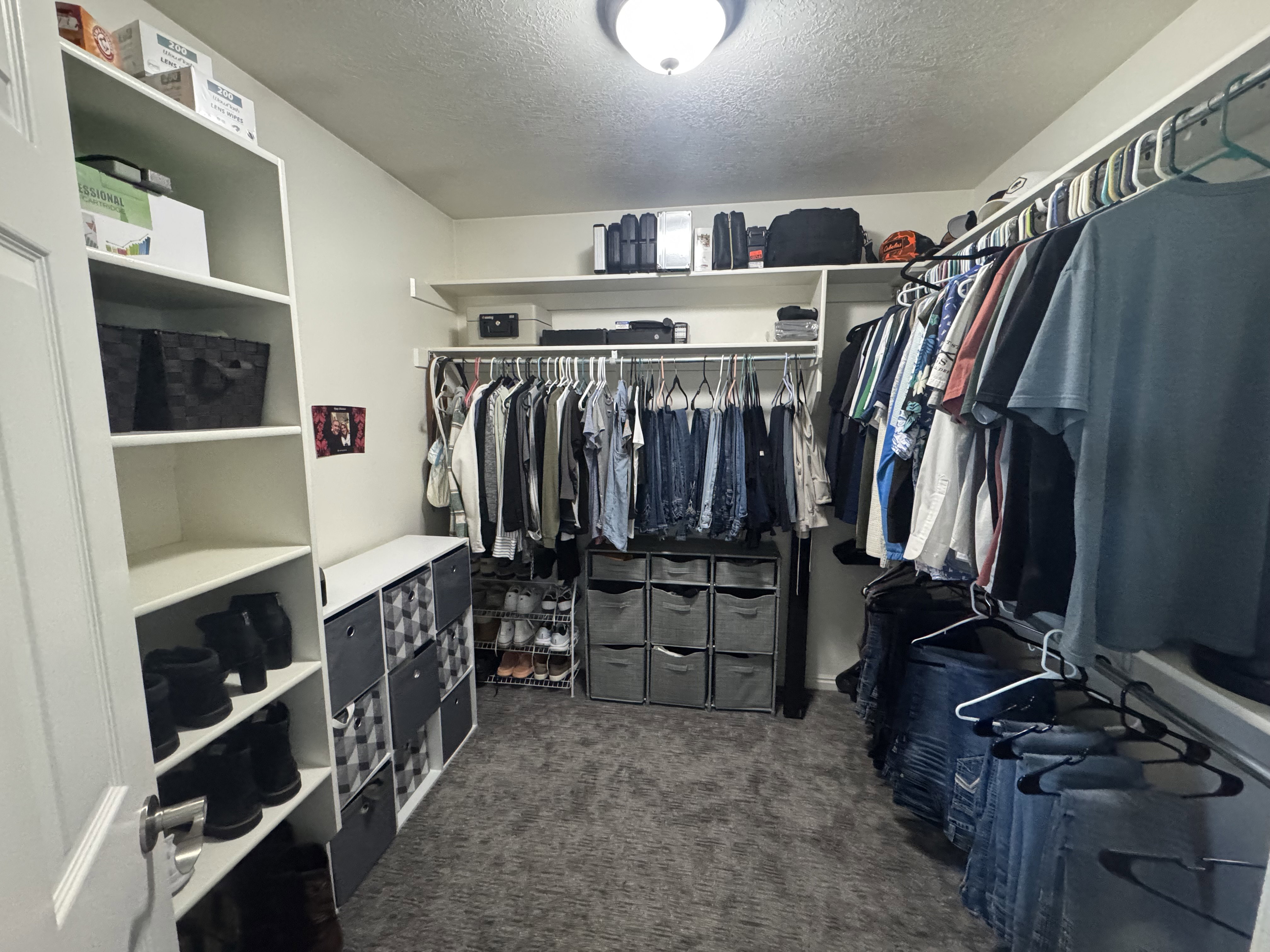 Walk-in closet featuring built-in shelving, multiple hanging rods, and recessed overhead lighting