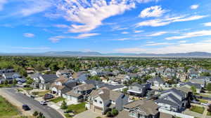 Expansive aerial view of a residential community, featuring a variety of single-family homes with multi-tone siding and attached garages