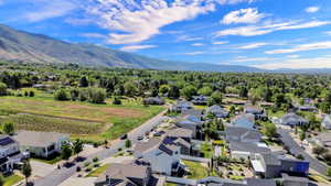 Expansive residential area featuring a mountain backdrop, mature trees, and a mix of traditional and modern architectural styles