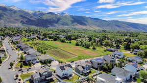 Aerial perspective showcasing a residential area with a prominent mountainous backdrop