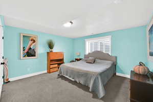 Spacious room featuring light blue walls, gray carpet, and a white ceiling