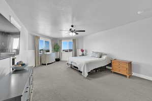 Spacious room featuring light gray carpeting and white walls