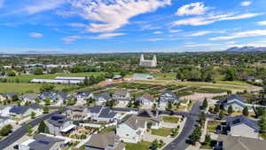 Aerial perspective of a suburban neighborhood featuring residential streets, individual homes with varying architectural styles, and landscaped yards