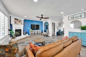 Open concept living space featuring wood-finish flooring and recessed lighting