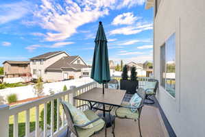 Outdoor deck space featuring a privacy railing, a light-colored exterior wall, and a sliding glass door
