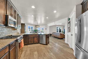 Kitchen featuring wood-finish flooring and recessed lighting