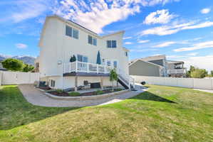 Rear exterior featuring a white stucco finish and multi-level outdoor living spaces
