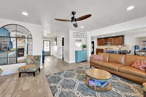 Spacious living area featuring wood-finish flooring, recessed lighting, and a ceiling fan