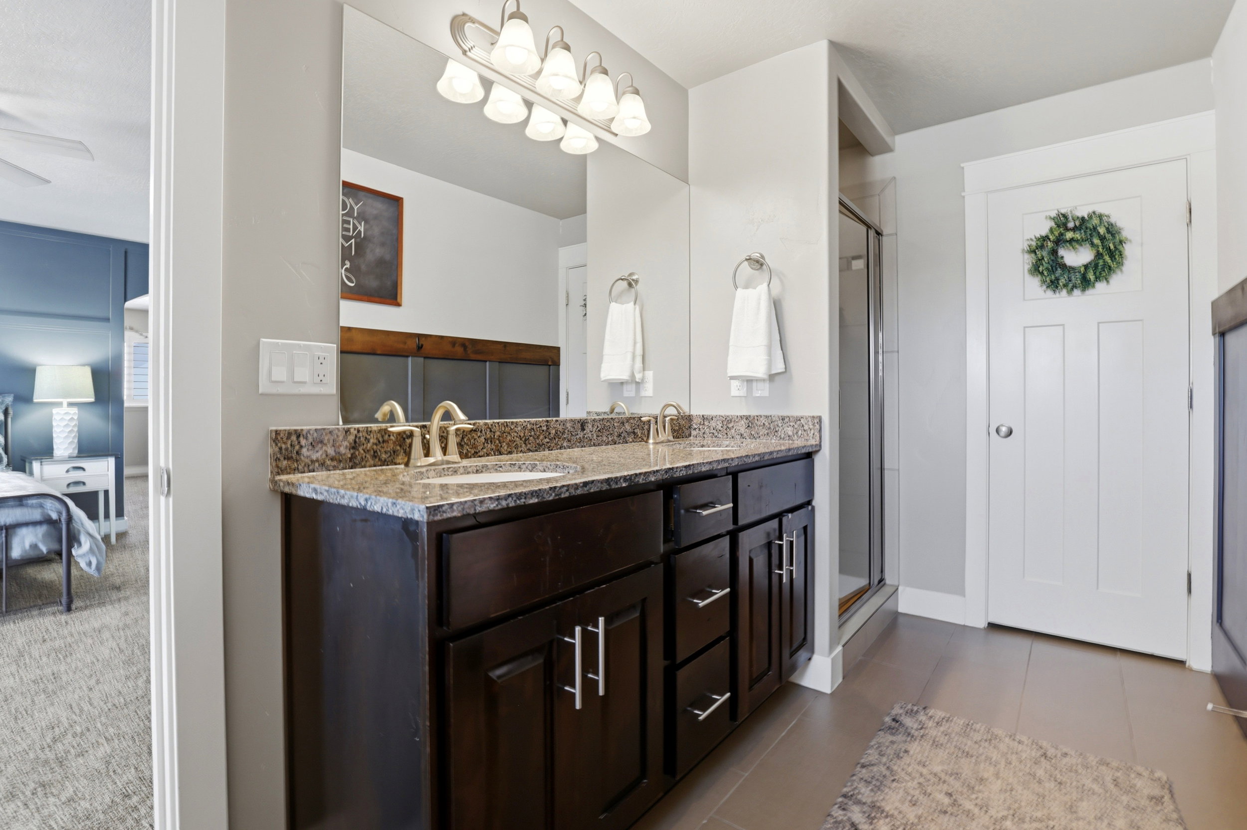 Dual vanity featuring a stone countertop and undermount sinks