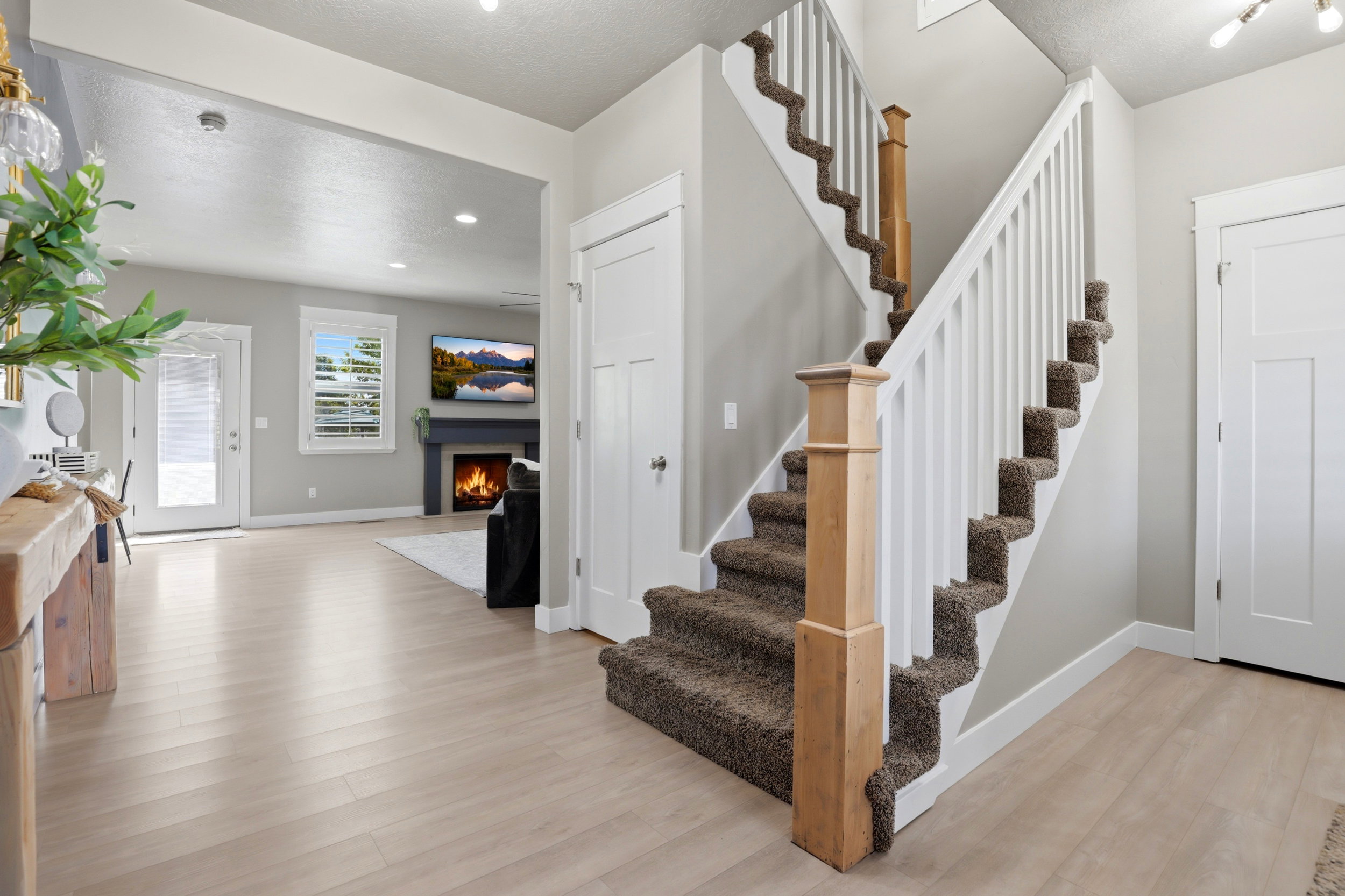 Staircase with carpeted treads and white wood balusters