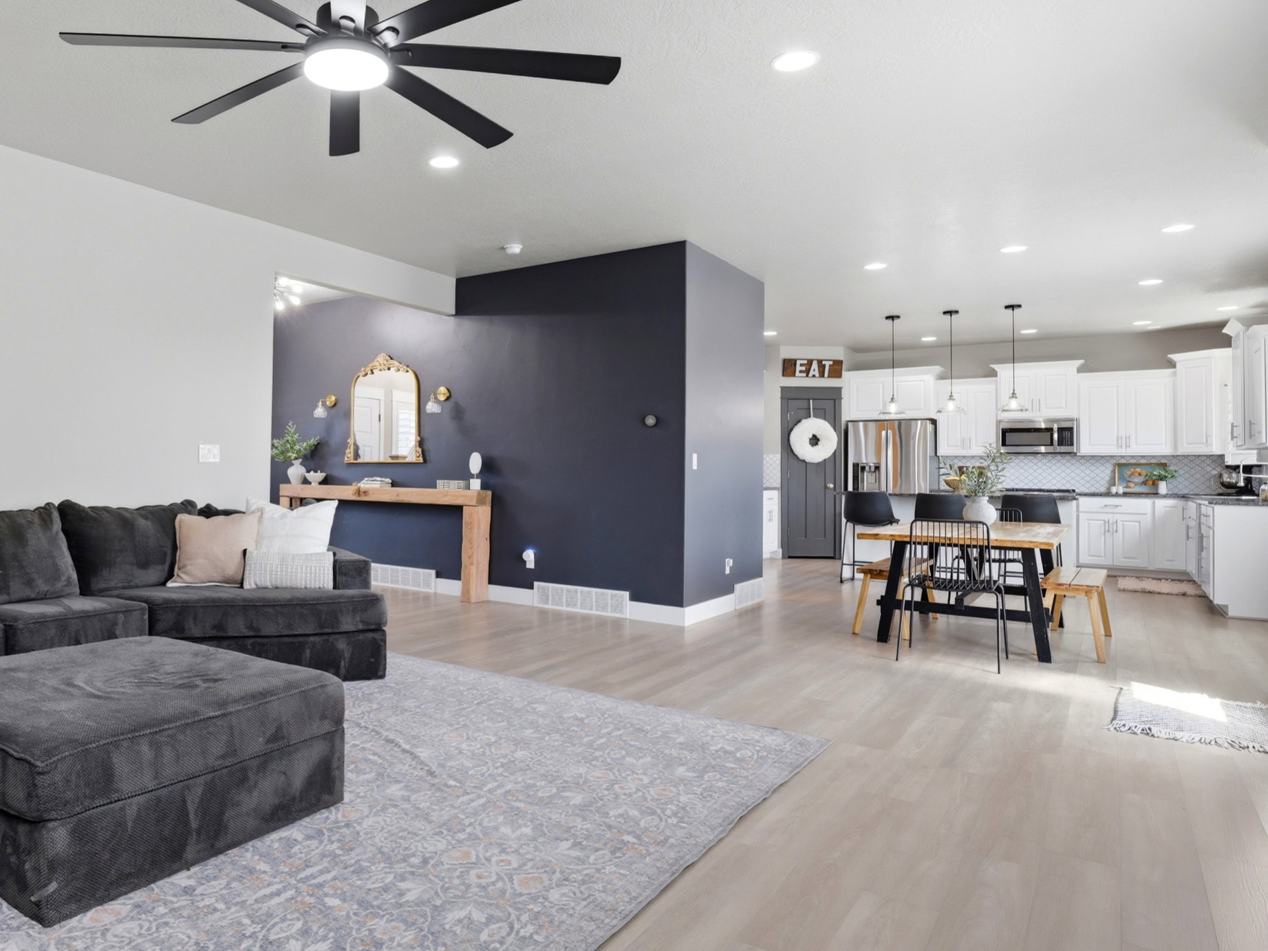 Open-concept living space featuring wood-finish flooring, recessed lighting, and a modern ceiling fan